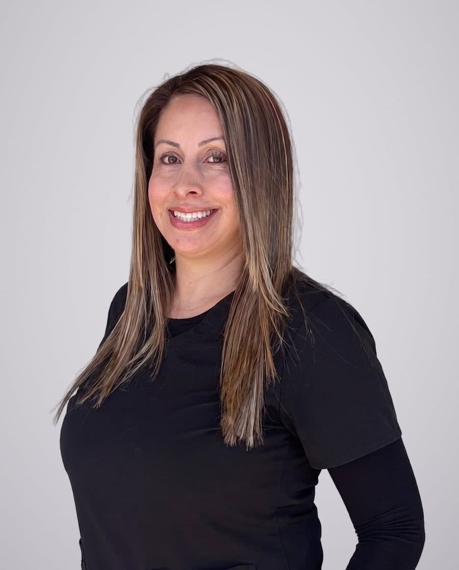 Veronica, front office manager at Oxnard Dental Office, in black scrubs